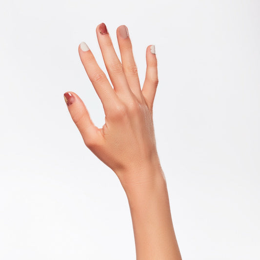 A woman's hand with colorful nail lacquer.