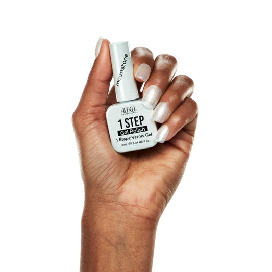Hand with Ardell Moonstone gel polish, showing off a luminous white manicure with a soft shimmer finish.