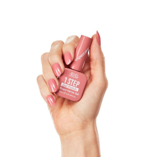 Model holding Ardell Impeccable gel polish bottle with matching nude pink manicure against white background.