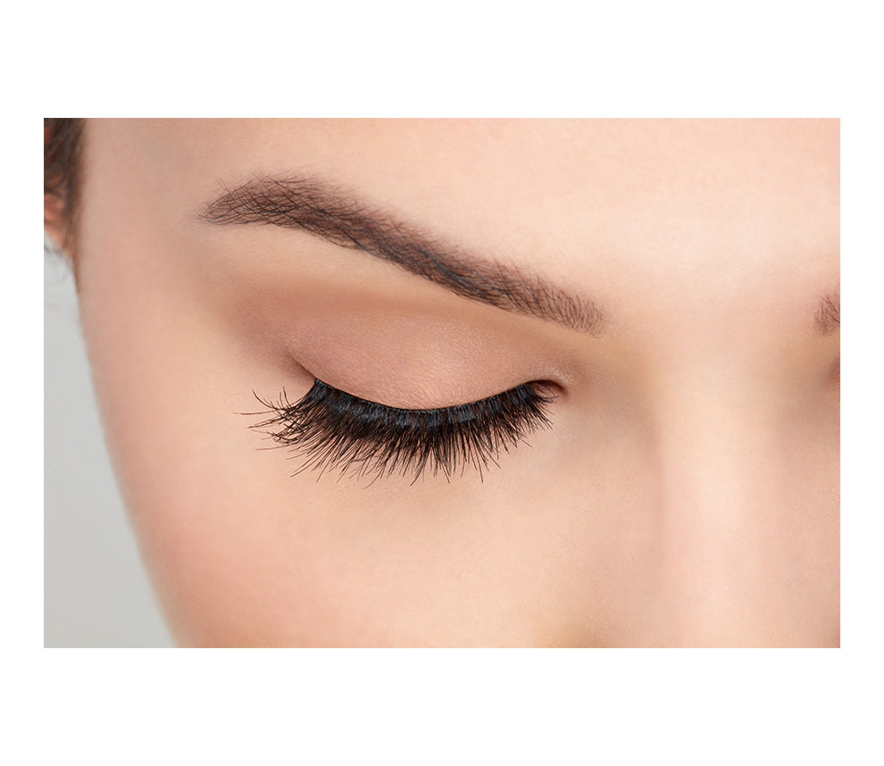 A model with a close right eye wearing Ardel Double Wispies showing its natural lash look