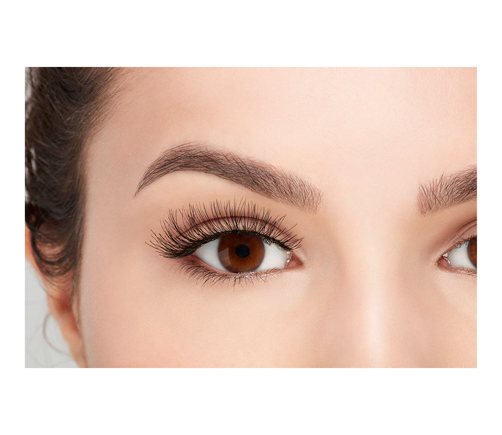 A model with an open right eye wearing Ardell Wispies showing how it looks like when it's worn