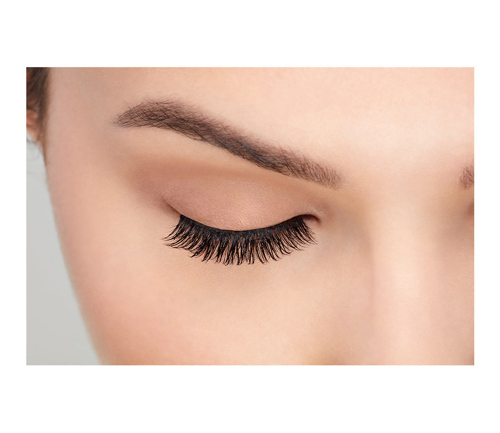 A model wearing Ardell's Faux mink 812 with close right eye showing its medium volume & long length, rounded lash