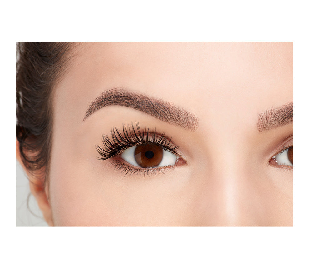 Front view of a model with one eye open wearing Ardell's Fauxmink Wispies to show how they look on the eye