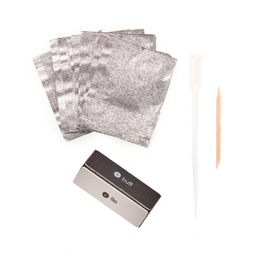 Out of pack image with foil sachets, acetone dropper, buffer block, and cuticle stick.