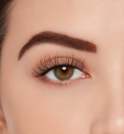 A model wearing Ardell's Ecolashes 450 with open right eye showing its extra-long layers with medium volume & fullness lash